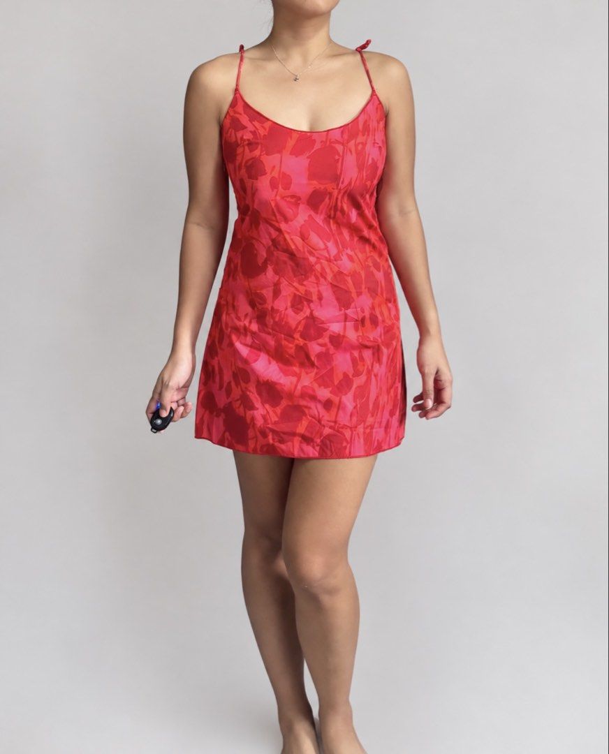 Red Floral Mini Slip Dress (Category: Dresses) located in Marikina City. Submitted by xyrezsani (Listing ID 1464900388, Image 1). Description: - Color: Red with all-over floral pattern - Style: Mini slip dress, straight neckline, above-the-knee length - Straps: Delicate double spaghetti straps - Material: Lightweight satin-like fabric - Versatility: Perfect for summer days or evening outings - Styling: Easy to pair with sandals or heels.