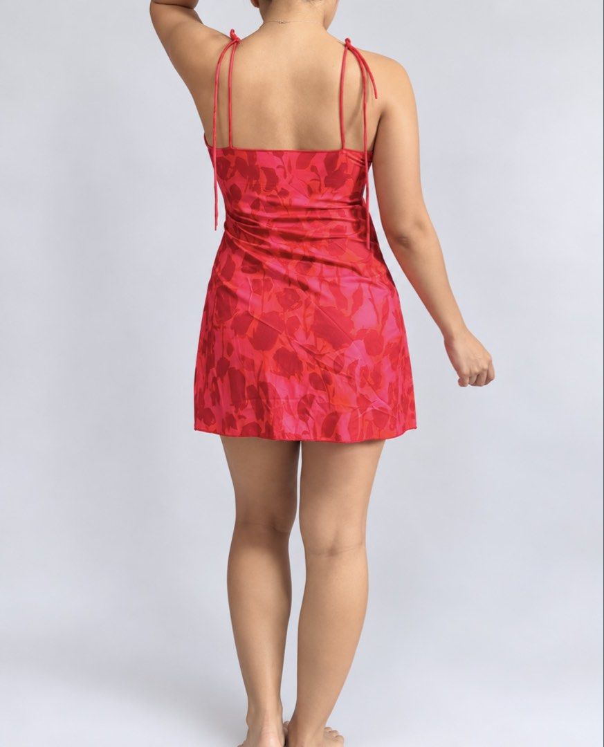 Red Floral Mini Slip Dress (Category: Dresses) located in Marikina City. Submitted by xyrezsani (Listing ID 1464900388, Image 2). Description: - Color: Red with all-over floral pattern - Style: Mini slip dress, straight neckline, above-the-knee length - Straps: Delicate double spaghetti straps - Material: Lightweight satin-like fabric - Versatility: Perfect for summer days or evening outings - Styling: Easy to pair with sandals or heels.