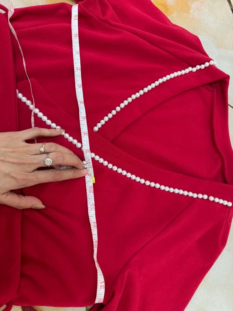 Red pearl-trimmed wrap (Category: Blouses) located in Caloocan City. Submitted by mylove326 (Listing ID 1464924258, Image 3). Description: - red top and open-front cardigan set - Chic white faux pearl accents along the lapel and wrap neckline - Soft and comfortable fabric with long sleeves and ribbed cuffs - Measures approximately 21 inches down the front - Versatile pieces that can be worn together or styled separately for work and play Bago po 