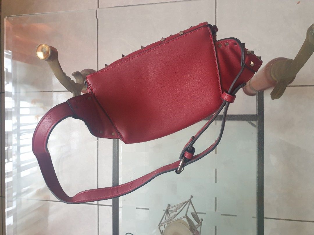 Red Quilted Studded Crossbody Bag (Category: Cross-body Bags) located in Bulacan. Submitted by mango_graham. (Listing ID 1464778366, Image 3). Description: - Color: Bold Red - Design: Metal studs with a quilted flap - Closure: Top zipper closure - Strap: Adjustable with buckle - Interior: Clean red fabric lining with a zippered side pocket - Origin: Made in China tag inside - Condition: Super clean, exterior and interior in great shape!.