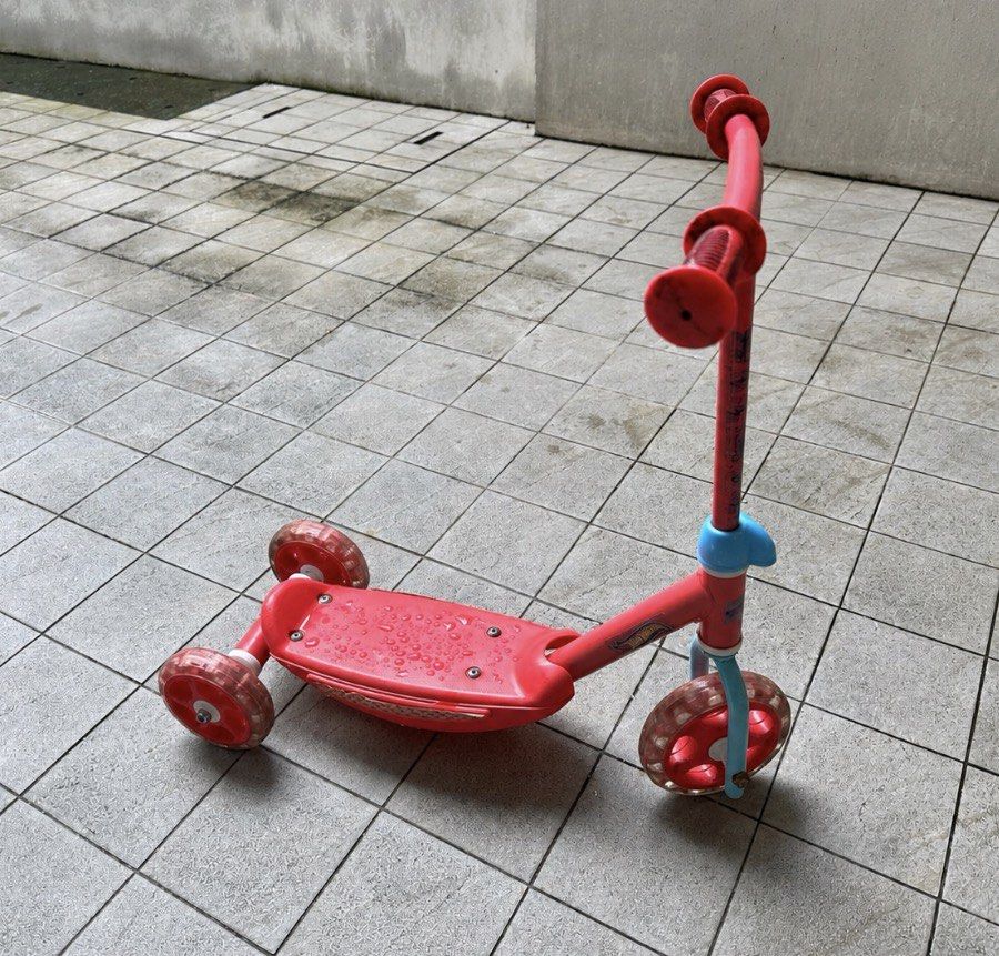 Red three-wheel kids kick scooter (Category: Skates, Rollerblades & Scooters) located in Muntinlupa City. Submitted by shopnb (Listing ID 1464782291, Image 2). Description: Cute and sturdy 3-wheel scooter for young kids — stable and easy to use for beginners. Features: * 3-wheel design for better stability * 2 rear wheels + 1 front wheel * Wide textured deck * Easy-grip handlebars * Rear foot brake * Adjustable-height handlebar * Lightweight and 
