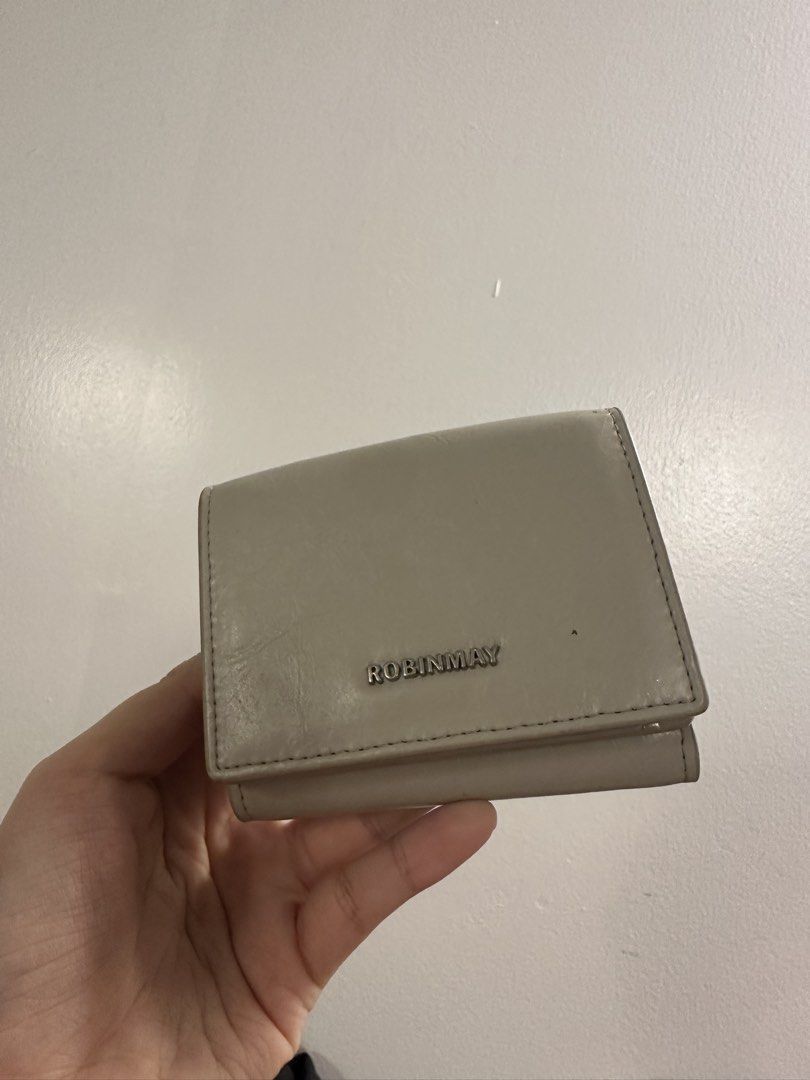 ROBINMAY Trifold Wallet Grey (Category: Wallets & Card holders) located in Makati City. Submitted by cosmicfire.4ba272 (Listing ID 1464913652, Image 1). Description: - Brand: ROBINMAY - Color: Sleek Grey - Style: Compact trifold wallet with minimalist design - Closure: Secure snap button - Storage: Multiple card slots and a dedicated cash compartment - Branding: Chic metal logo on the front - Condition: Brand new and 100% authentic - Perfect for 