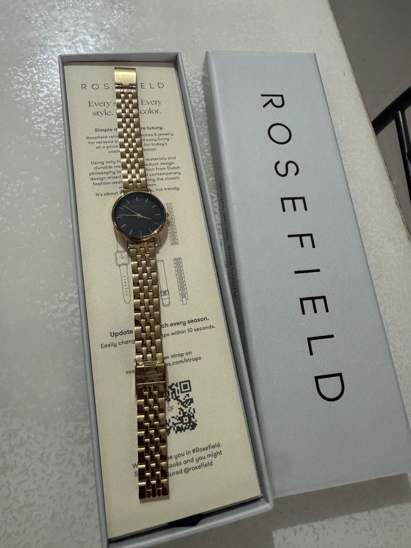 Rosefield Gold Watch with Black Dial (Category: Women's Watches) located in Cavite. Submitted by marcuz1316 (Listing ID 1464901194, Image 3). Description: - Brand: Rosefield - Color: Polished gold finish with a striking black dial - Design: Minimalist analog face with thin gold hour markers - Strap: Metal link bracelet - Inclusions: Original branded box and paper insert - Condition: Classic everyday timepiece in sleek condition.