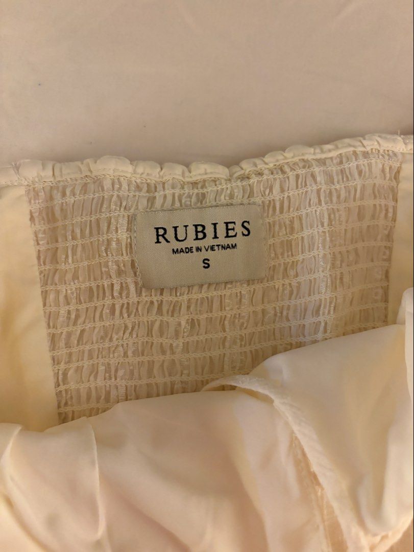 Rubies Saigon Ecru Cream Flowy Ruffled Smocked Top (Category: Sleeveless) located in Makati City. Submitted by chiclane_ (Listing ID 1464874064, Image 3). Description: pretty fabric! can be worn with the straps as cold shoulder top or off shoulder bought from rubies vietnam brand for reach only.
