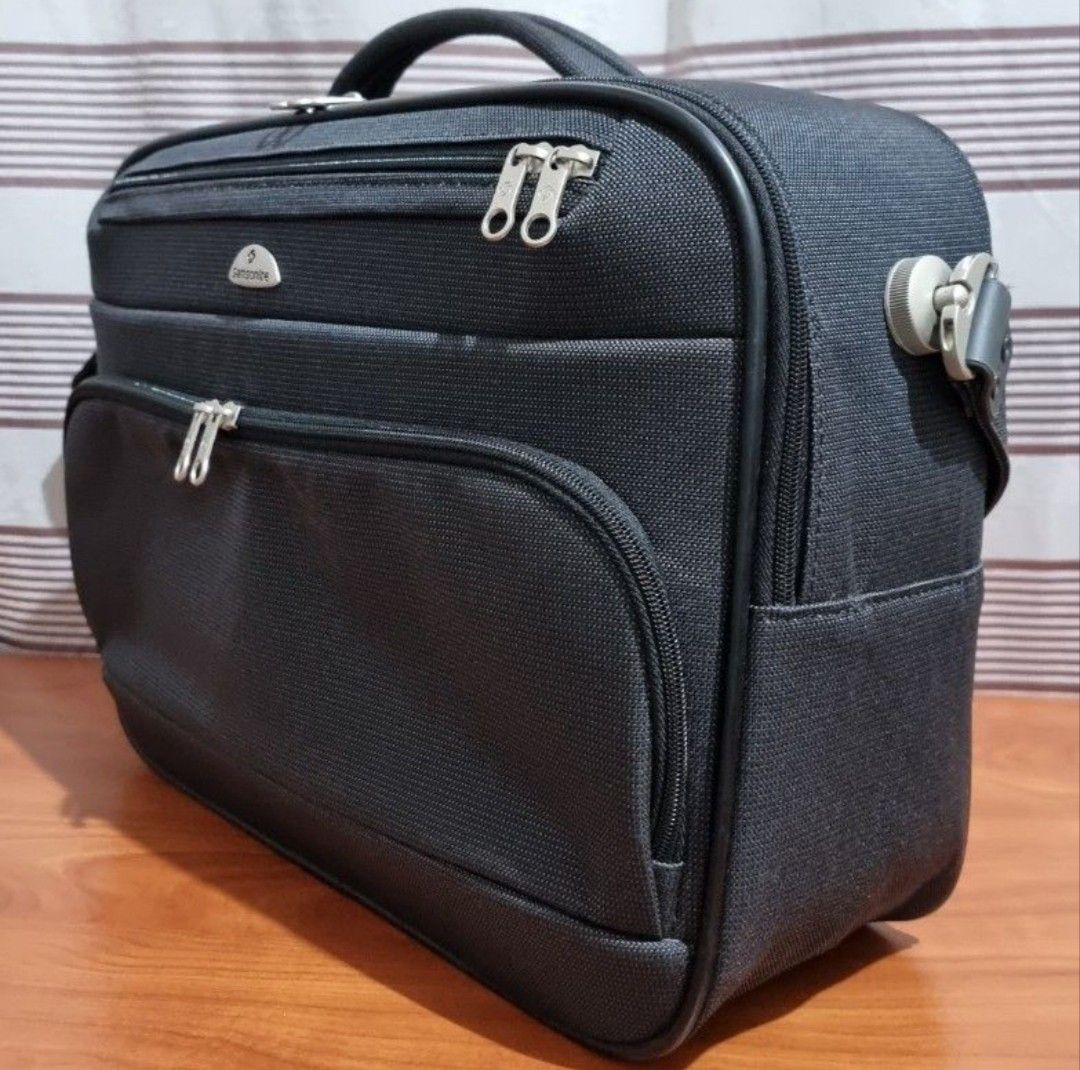 Samsonite Black Business Briefcase Shoulder Bag (Category: Briefcases) located in Manila. Submitted by lene48 (Listing ID 1464774260, Image 1). Description: - Authentic Samsonite business bag in sleek black textile - Multiple zipped front and top compartments for easy organization of documents and electronics - Durable top handle and comfortable adjustable shoulder strap with sturdy metal hardware - Signature branded zippers with classic Samsonit