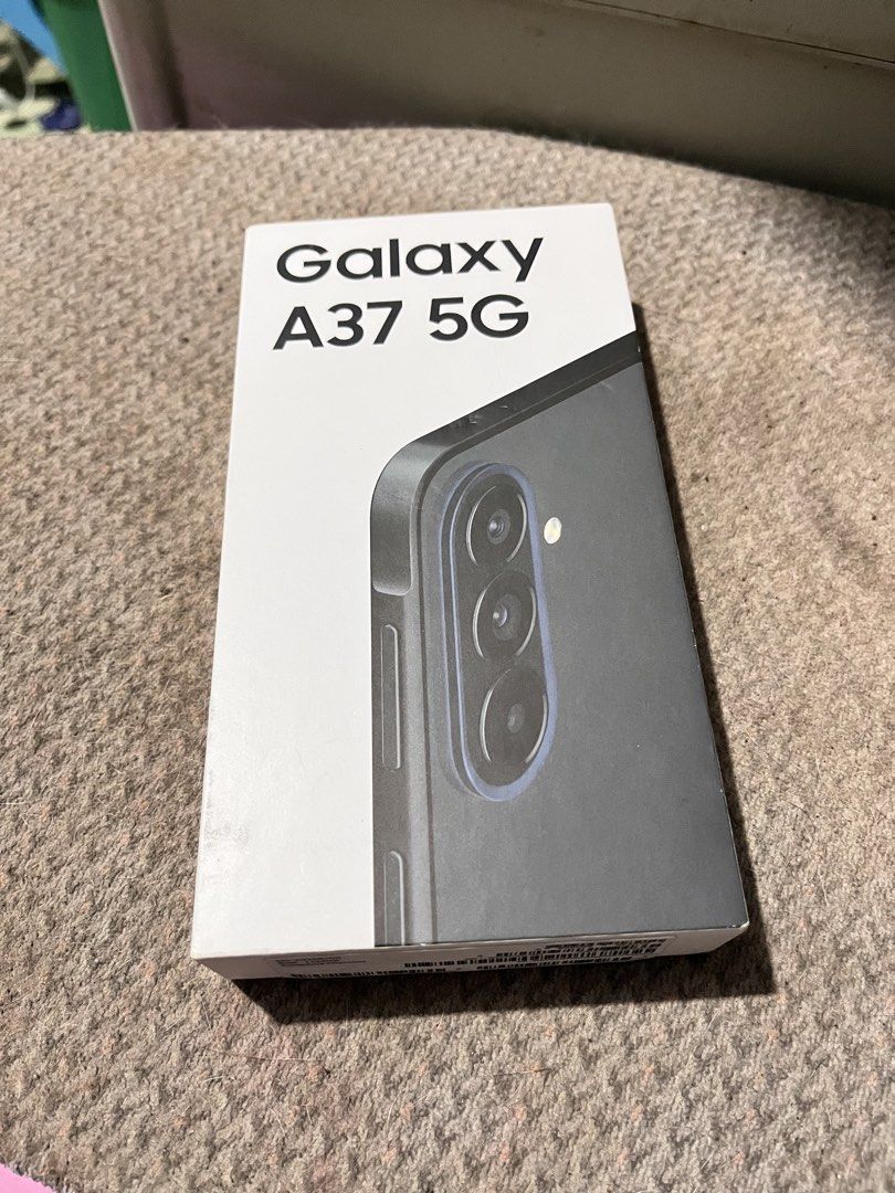 Samsung A37 5G 128GB (Category: Samsung) located in Manila. Submitted by edenroseg (Listing ID 1464814311, Image 1). Description: SAMSUNG Galaxy A37 5G is a smartphone that features a 6.7-inch FHD+ Super AMOLED display, 50MP + 8MP + 5MP triple rear cameras with OIS, and a 12MP selfie camera. It runs on an Exynos 1480 chipset with 8GB of RAM, Android 16 OS, OneUI 8 software and AI capabilities. There’s also an under-display fingerprint scanner, 5G