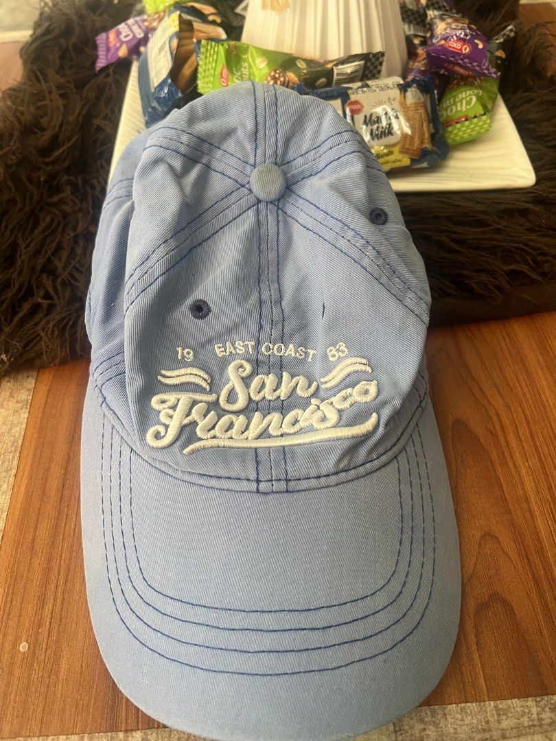 San Francisco East Coast Blue Baseball Cap (Category: Caps & Hats) located in Manila. Submitted by declutteringlangpo (Listing ID 1464780456, Image 1). Description: - Color: Light blue with white San Francisco embroidery - Details: '19' and '83' embroidered on the sides - Fit: Adjustable metal strap in the back for a custom fit - Design: Classic curved brim with breathable top eyelets - Condition: Clean inner lining with standard stitching.