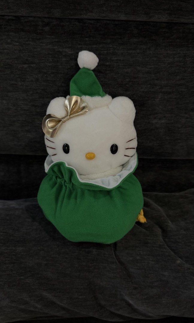 Sanrio Hello Kitty Christmas Plush (Category: Plushies & Soft Toys) located in Cabadbaran. Submitted by cinnamororr (Listing ID 1464961776, Image 2). Description: - Adorable Kitty plush dressed in a festive green - Features a sparkly gold bow on the ear, white collar, and black boots - Includes a cute white gift bag strapped to the back with yellow rope - Original tag still attached to the side - Clean fabric and bright, vibrant colors throughout