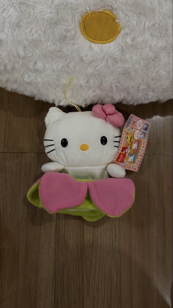 Sanrio Hello Kitty Flower Pouch Plush (Category: Plushies & Soft Toys) located in Cabadbaran. Submitted by cinnamororr (Listing ID 1464960868, Image 1). Description: - Authentic Banpresto Sanrio Kitty plush - Adorable green and pink flower pouch design - Features a functional bottom pocket/pouch opening - Equipped with a hanging loop at the top - Comes with original tag attached - Soft white fur body with classic pink bow and embroidered whiskers