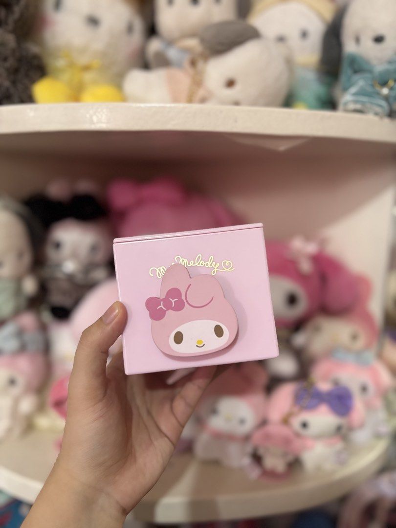 Sanrio My Melody Pink Storage Box (Category: Storage Boxes & Baskets) located in Abucay. Submitted by leeeeeeeeeeen (Listing ID 1464904814, Image 1). Description: - Authentic Sanrio pink storage box featuring My Melody - Features a cute raised My Melody character with stylish gold cursive text - Square shape complete with a matching lid - Beautiful pastel pink color to match any aesthetic - Perfect for organizing small items on your desk, vanity,