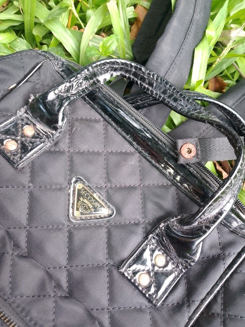 Secosana Black Quilted Backpack with Handles (Category: Backpacks) located in Tabaco. Submitted by cuniie (Listing ID 1464912956, Image 2). Description: - Brand: Secosana - Material: Durable black quilted nylon with shiny patent leather top handles - Features: Front zipped pocket, secure top zip closure, and adjustable back straps - Hardware & Logo: Elegant gold-tone hardware with a triangular Secosana metal logo plate - Condition: Shows some pee