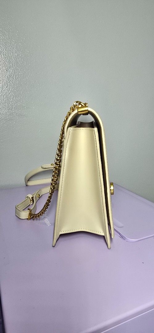 Secosana Off-White Shoulder Bag with Gold Hardware (Category: Shoulder Bags) located in Manila. Submitted by chubbychic553 (Listing ID 1464923054, Image 2). Description: - Brand: Secosana - Color: Off-white - Material: Premium synthetic leather with structured rectangular shape - Closure: Elegant gold-tone turn-lock on the front flap - Straps & Accents: Includes a matching adjustable shoulder strap and decorative gold chain link detail - Branding