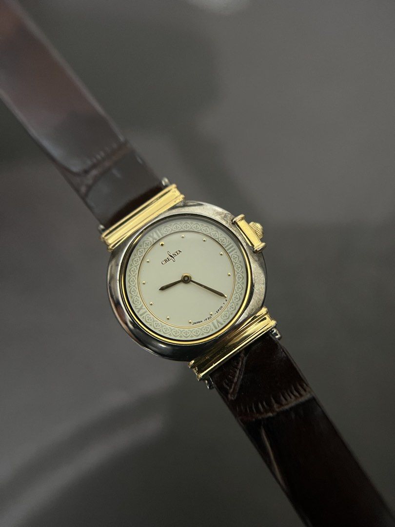 Seiko Cresta Two-Tone Patterned Dial Quartz – Ref. 1F20-0K60 (Category: Women's Watches) located in Quezon City. Submitted by bobby.brown. (Listing ID 1464916135, Image 1). Description: Seiko Cresta Two-Tone Patterned Dial Quartz – Ref. 1F20-0K60 Estimated BMBY: September 1992 An elegant vintage dress watch from Seiko’s Cresta line, featuring a round base metal case with a polished bezel and gold-tone decorative lug elements. The off-white dial i