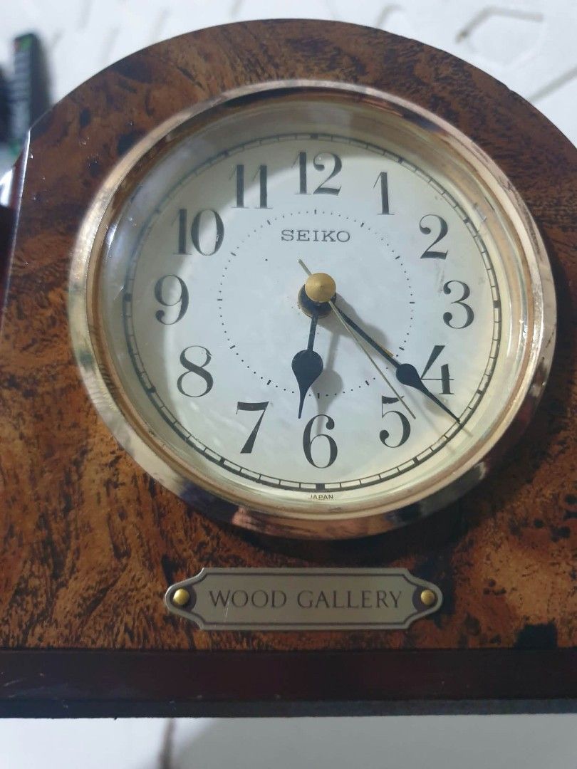 Seiko Wood Gallery Mantel Clock (Category: Clocks) located in Manila. Submitted by miguellags_ (Listing ID 1464879993, Image 3). Description: - Authentic vintage Seiko desk clock with Japan movement - Elegant wooden arch frame with a polished brass bezel - Clean white face with bold black numerals and vintage hands - Features a charming "Wood Gallery" plaque at the base - Includes back battery compartment and easy adjustment knob - Perfect aesthe
