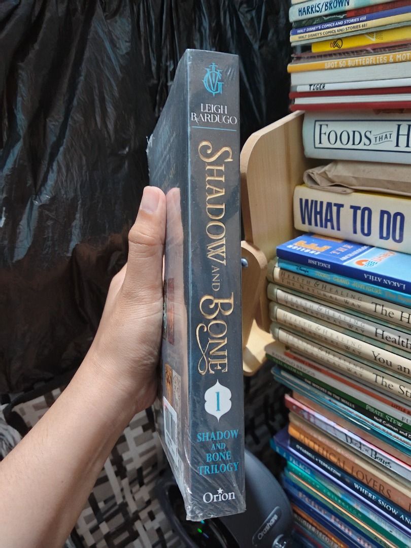 Shadow and Bone by Leigh Bardugo Paperback (Category: Storybooks) located in Taguig. Submitted by jener.498 (Listing ID 1464925898, Image 2). Description: - Title: Shadow and Bone by Leigh Bardugo - Edition: Orion publishing with Netflix series sticker - Condition: Brand new, still sealed in original plastic wrap - Status: Unopened and unused.