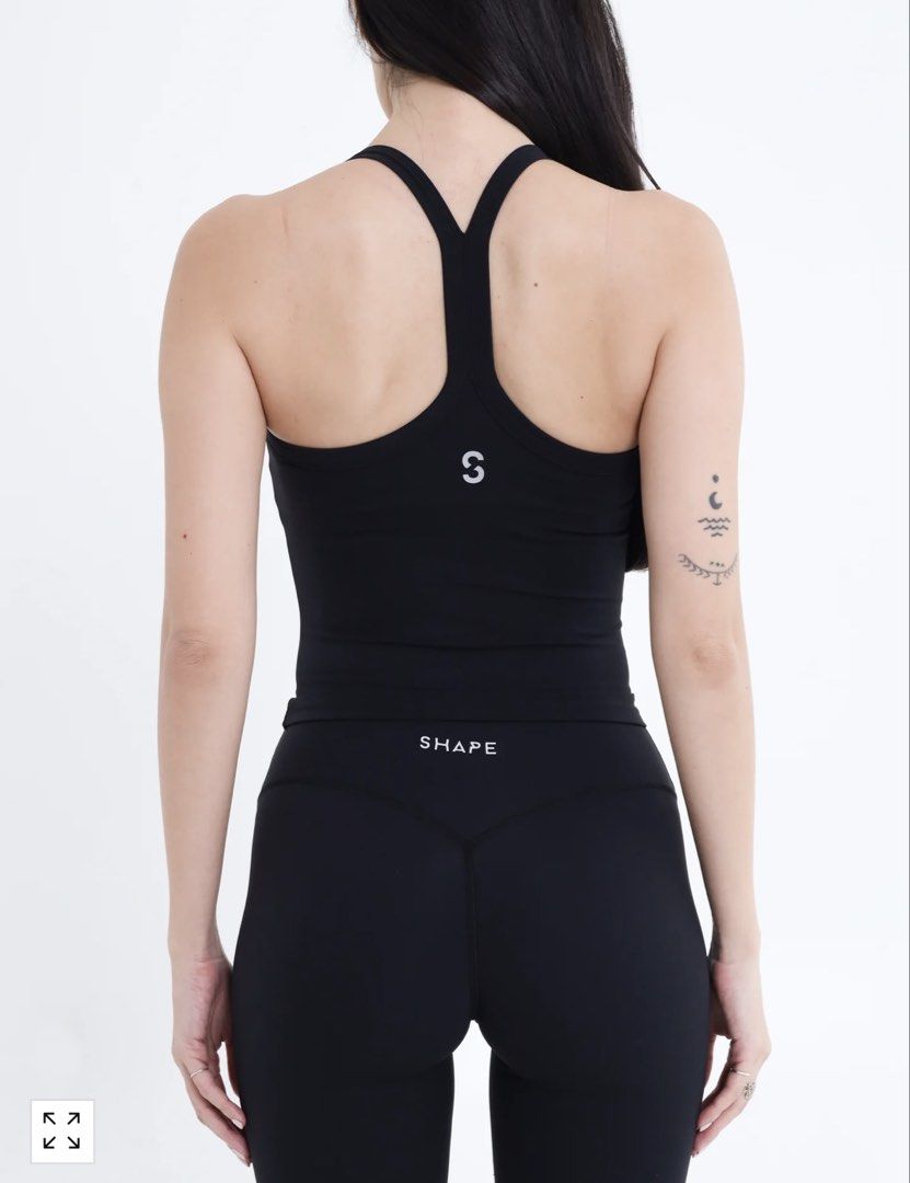 SHAPE Black Racerback Activewear Tank Top (Category: Activewear) located in Mandaluyong City. Submitted by luvieestbelle (Listing ID 1464868381, Image 2). Description: - Brand: SHAPE - Color: Black - Style: Scoop neck with skinny racerback - Details: Small 'S' logo on back collar - Fit: Soft, stretchy fabric that hugs the body closely - Length: Sits right around the hip line - Ideal for: Workouts, gym sessions, and pairing with matching leggings 