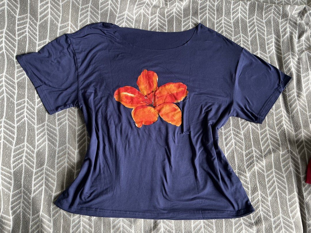 Shein Assymetrical Beach Top Size L (Category: Others Tops) located in Manila. Submitted by dirtymatcha05 (Listing ID 1464791457, Image 3). Description: - Shein Assymetrical Top - This navy blue t-shirt features a vibrant red and orange hibiscus flower graphic on the front. - no issues - only worn once.