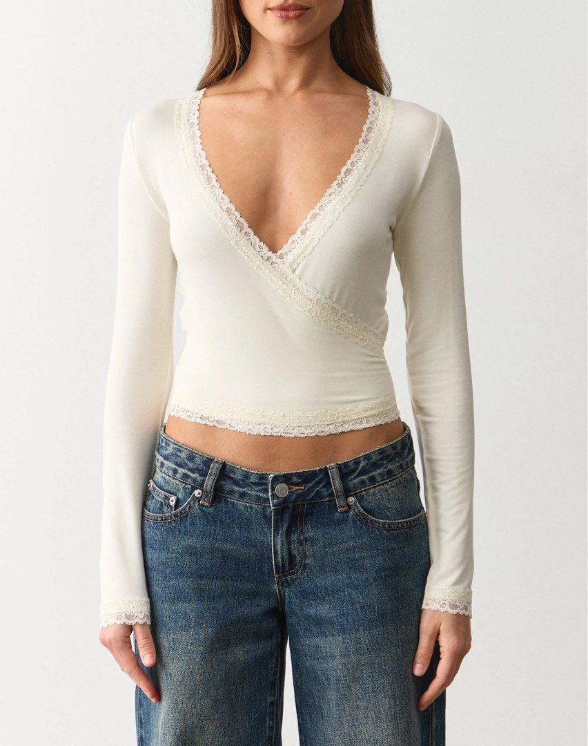 Shein Cream Lace Trim Wrapover Top (Category: Longsleeves) located in Binan City. Submitted by myprelovedhaul (Listing ID 1464934807, Image 2). Description: - fits xs to medium! - no when worn photos! - last price posted! - please message only if sure buyer! - limited replies only. - Available unless mark as sold. - Ship via j&t or lalamove for same day. -Mode of payment: Gcash 📍Biñan Laguna The highlighted item is a long-sleeve wrap crop top wi