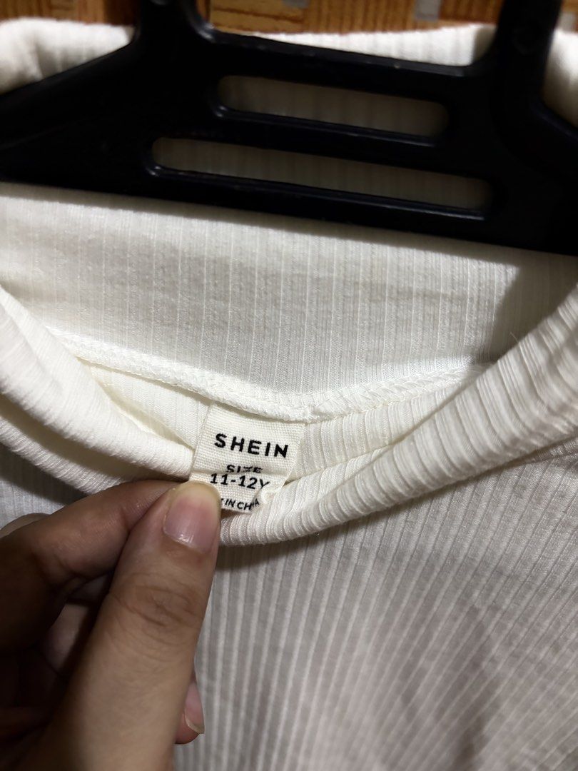 SHEIN White Ribbed Turtleneck Top 11-12Y (Category: Babies & Kids Fashion) located in Pangil. Submitted by chel_anne (Listing ID 1464835645, Image 3). Description: - Brand: SHEIN - Color: White - Size: 11-12 years - Material: Stretch ribbed fabric - Style: Long sleeve turtleneck - Condition: Great basic piece, easy to mix and match for cooler weather.