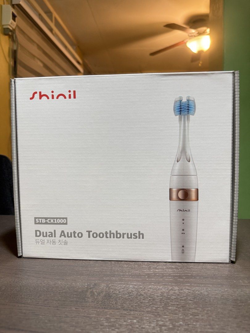 Shinil Dual Auto Toothbrush STB-CX1000 (Category: Oral Care) located in Manila. Submitted by trashy13 (Listing ID 1464798762, Image 1). Description: - Brand: Shinil - Model: STB-CX1000 - Color: Elegant White and Rose Gold - Condition: Brand new, unopened box - Features: Dual auto brush heads for efficient cleaning - Packaging: Original box included.