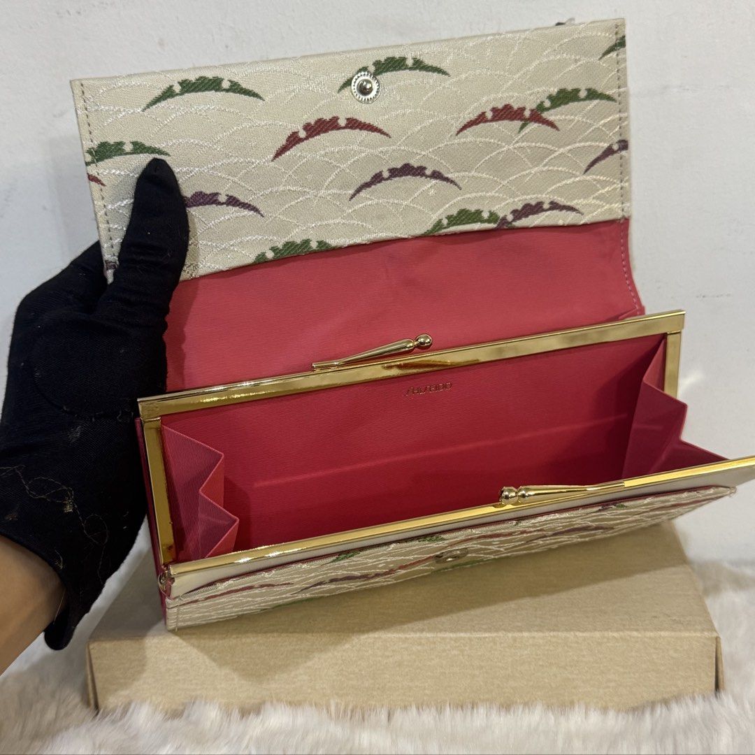 Shiseido Japanese Fabric Pattern Long Wallet with Box (Category: Wallets & Card holders) located in Rizal. Submitted by houseofbell (Listing ID 1464943901, Image 2). Description: - Brand: Shiseido - Type: Long wallet / Kiss-lock purse - Exterior: Beige fabric with traditional Japanese textile pattern - Interior: Vibrant pink lining with spotless compartment - Hardware: Gold-tone frame and kiss-lock closure - Inclusions: Comes with original plain 