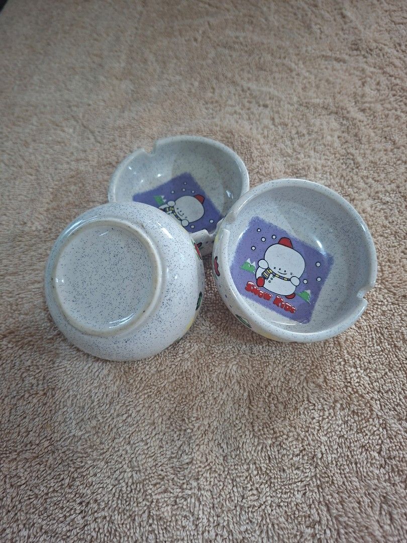 Snow Kids Small Ash Tray (Category: Other Stationery & Craft) located in Consolacion. Submitted by luxekerei (Listing ID 1464773723, Image 3). Description: - vintage ceramic ashtrays featuring a "Snow Kids" snowman illustration on a speckled stone-textured base..