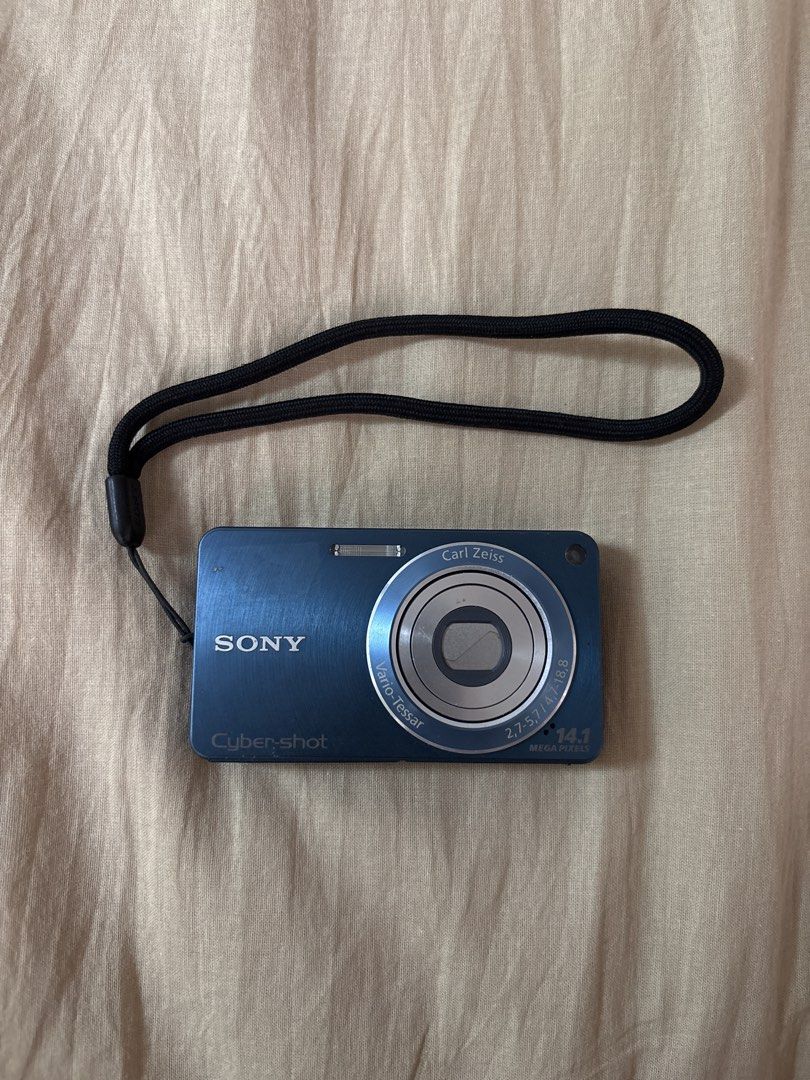 Sony Cyber-shot 14.1 Megapixels Digital Camera Blue (Category: Cameras) located in Manila. Submitted by empressbluemoon (Listing ID 1464842593, Image 1). Description: - Model: Sony Cyber-shot Digital Camera (Blue) - Resolution: 14.1 Megapixels - Lens: Carl Zeiss Vario-Tessar - Condition: Tested and working fine, minor scuffs on metal casing from normal use, clean lens glass - Features: Built-in flash - Inclusion: Black wrist strap attached.