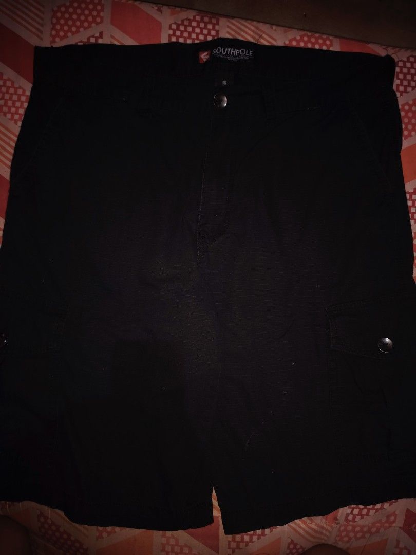 Southpole Black Cargo Shorts Size 36 (Category: Shorts) located in Roxas, Palawan. Submitted by act_thrift_palawan (Listing ID 1464869817, Image 2). Description: - Brand: Southpole - Size: 36 waist - Color: Black - Fabric: Sturdy with ripstop grid texture - Pockets: Multiple utility pockets with button closures - Closure: Button fly front - Details: Branded waistband label inside - Condition/Use: Great casual shorts for daily wear.