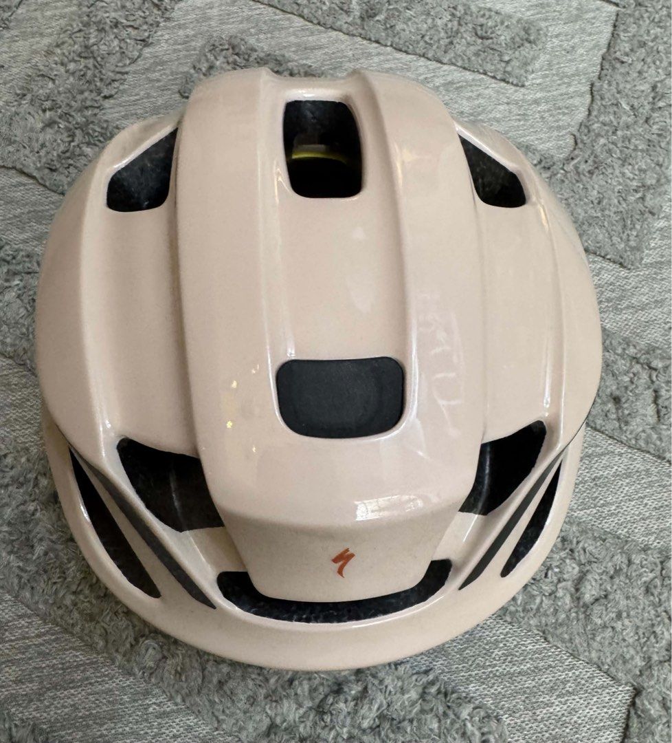Specialized Bike Helmet with MIPS Beige (Category: Bicycles) located in Bacoor. Submitted by luvtoshoppe (Listing ID 1464813348, Image 2). Description: - Brand: Specialized bicycle helmet - Color: Soft beige with brown straps and black buckle - Safety: Equipped with MIPS safety system for enhanced head protection - Ventilation: Multiple ports on top and sides for optimal airflow - Branding: Orange Specialized logo on front and rear.