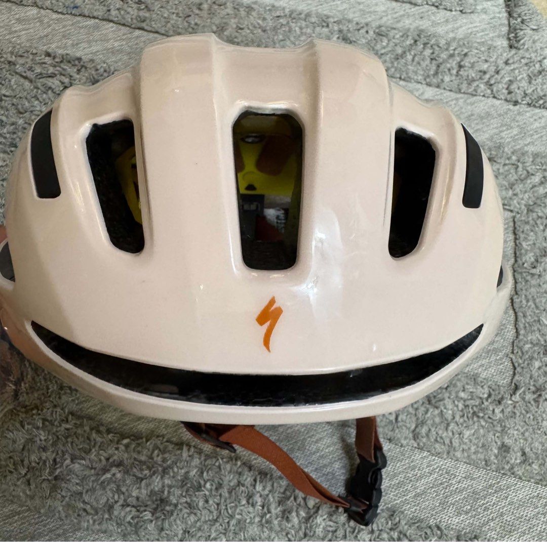 Specialized Bike Helmet with MIPS Beige (Category: Bicycles) located in Bacoor. Submitted by luvtoshoppe (Listing ID 1464813348, Image 1). Description: - Brand: Specialized bicycle helmet - Color: Soft beige with brown straps and black buckle - Safety: Equipped with MIPS safety system for enhanced head protection - Ventilation: Multiple ports on top and sides for optimal airflow - Branding: Orange Specialized logo on front and rear.