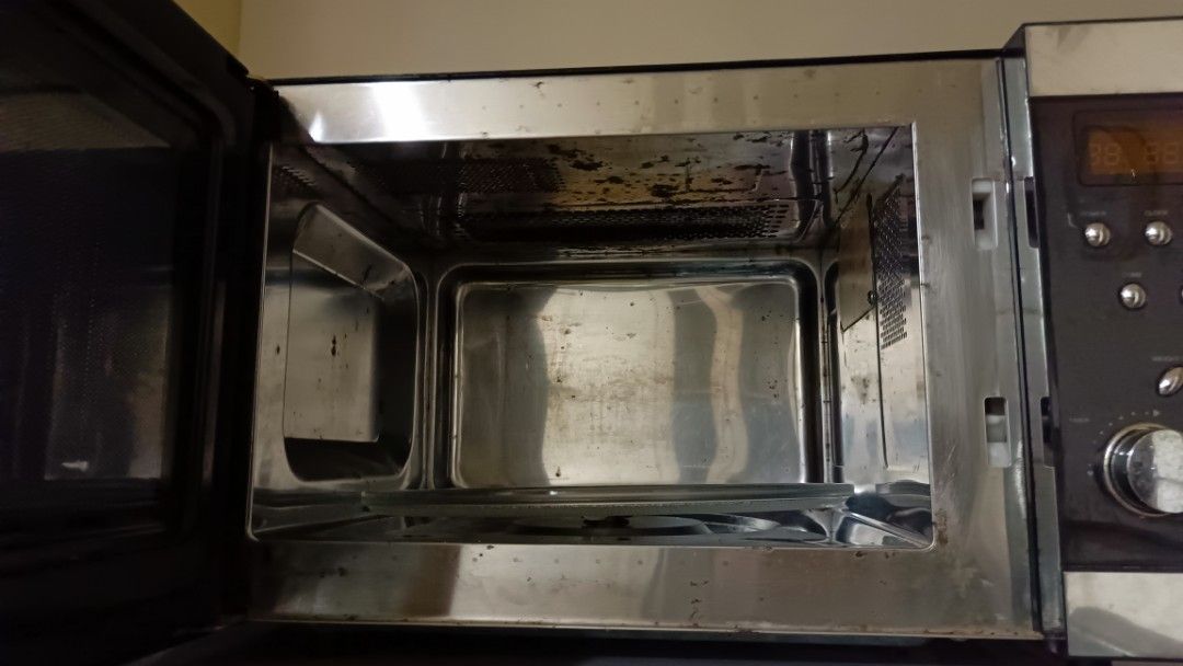 Stainless Steel Microwave with Handle and Digital Display (Category: Ovens & Toasters) located in San Juan City. Submitted by pinkdenxel (Listing ID 1464900209, Image 2). Description: - Type: Stainless steel countertop microwave - Features: Digital clock display, multi-control buttons, side dial, and glass turntable - Design: Black finish body with stylish stainless steel trim and handle door mechanism - Power: Standard plug (tested and powers on