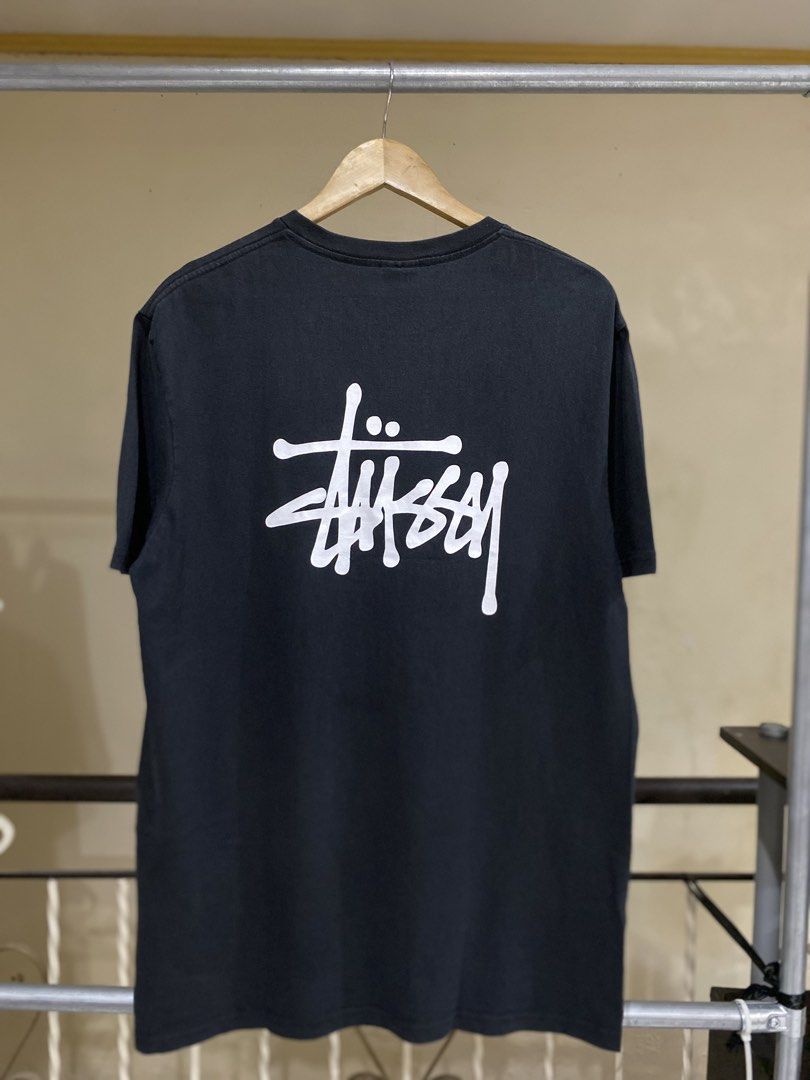 Stüssy Black Graphic Tee Size XL (Category: Tshirts & Polo Shirts ) located in Rizal. Submitted by channzy (Listing ID 1464920372, Image 1). Description: - Brand: Stüssy - Color: Black - Size: XL (Standard Fit) - Material: 100% Cotton (Machine wash cold, tumble dry low) - Design: Small white signature logo on left chest, large signature graffiti logo on back - Details: Crew neck, short sleeves, clean inner tags - Condition: 100% authentic and wel
