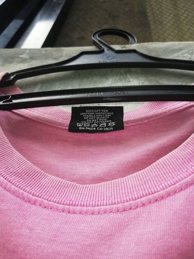 Stussy Pink Graphic Tee Size M (Category: Tshirts & Polo Shirts ) located in Manila. Submitted by kiraaaaaaaaaaa (Listing ID 1464838783, Image 2). Description: - Brand: Stussy - Size: Medium - Color: Pink - Material: 100% cotton, made in Mexico - Design: Small front chest logo with a large Africa graphic, Rastafari colors, and text print on the back - Fit: Regular fit, ideal for casual streetwear - Care: Wash care instructions printed inside the 