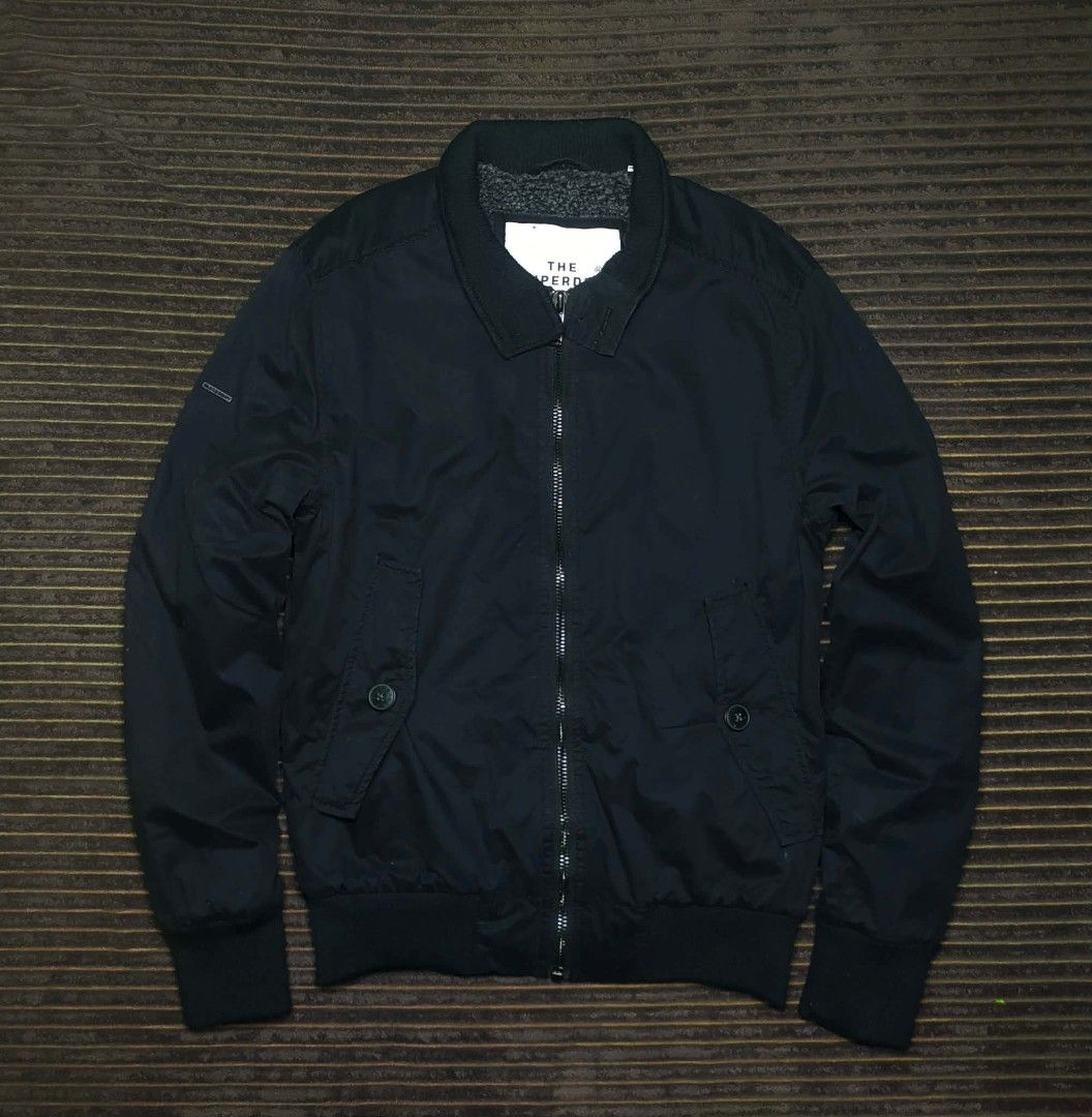 Superdry Co. Black Bomber Jacket Size Small (Category: Coats, Jackets and Outerwear) located in Manila. Submitted by norathrifted (Listing ID 1464771071, Image 2). Description: - Brand: Superdry Co. - Size: Small - Color: Black with fuzzy grey fleece lining - Closure: Full zip front - Pockets: Front buttoned flap pockets - Details: Structured collar, ribbed cuffs, collar, and hem - Condition: Excellent, clean everyday outer layer.
