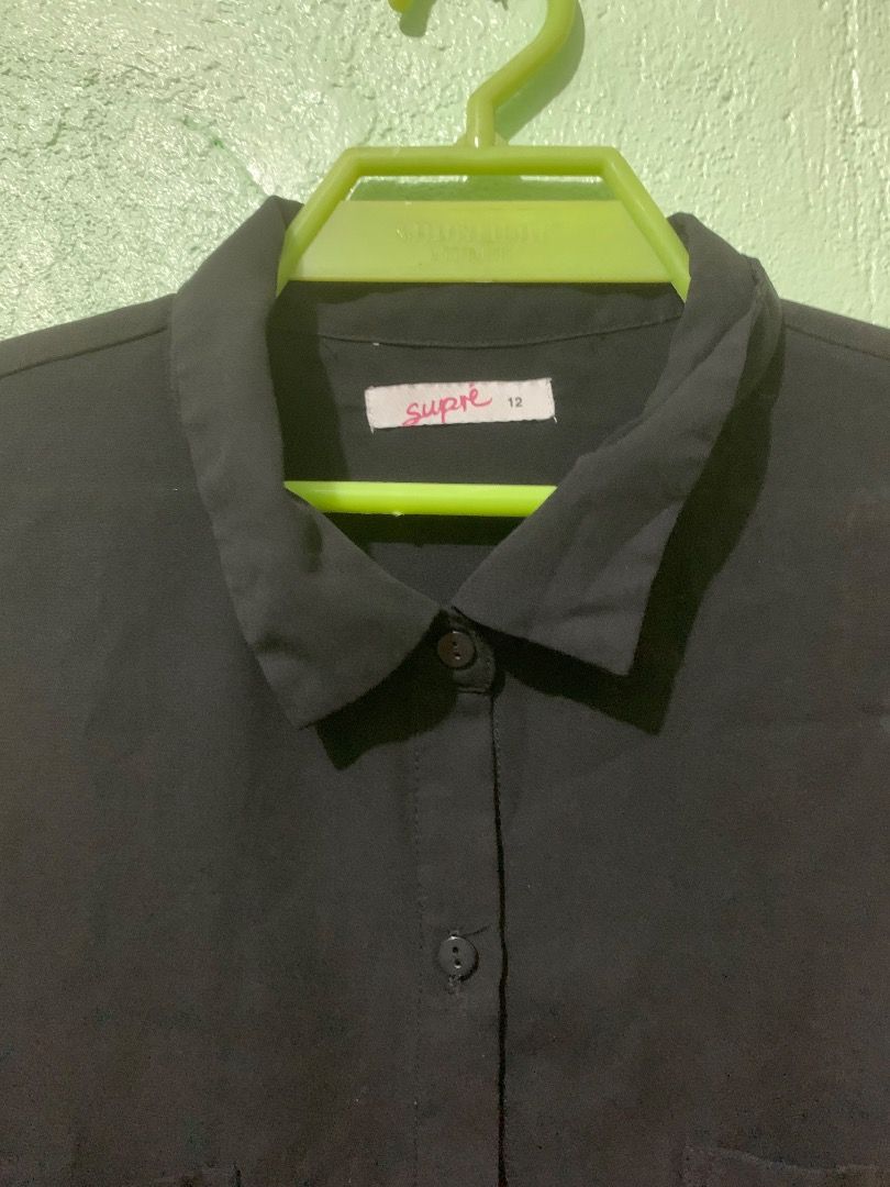 Supré Black Button-Up Long Sleeve Shirt Size 12 (Category: Longsleeves) located in Daraga. Submitted by ryrilim (Listing ID 1464924151, Image 2). Description: - Brand: Supré - Size: AU/UK 12 - Color: Solid black - Material: Lightweight and comfortable fabric - Features: Long sleeves, standard collar, two chest pockets, curved hem - Style: Versatile basic piece, easy to match with any outfit - Condition: Excellent, ready to wear.