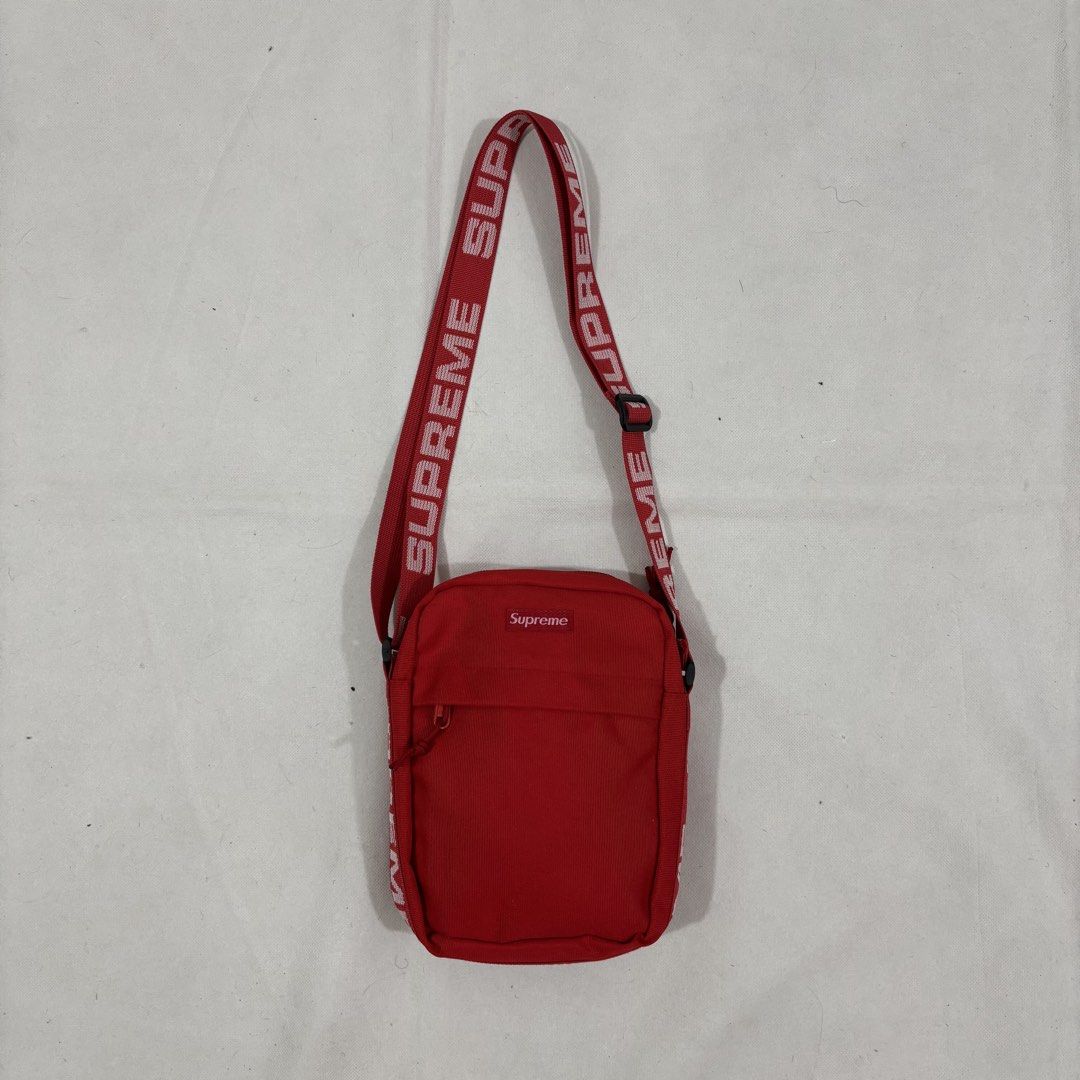 Supreme Red Shoulder Bag Crossbody (Category: Sling Bags) located in Cavite. Submitted by itsayaaa (Listing ID 1464836882, Image 1). Description: - Brand: Supreme - Color: Vibrant red with bold white logo straps - Storage: Front zip pocket and main compartment with inner zip pocket - Details: Features 'Made in China' inner tag, clean interior lining - Fit: Adjustable strap with durable buckle hardware - Condition: Excellent, clean and well-mainta