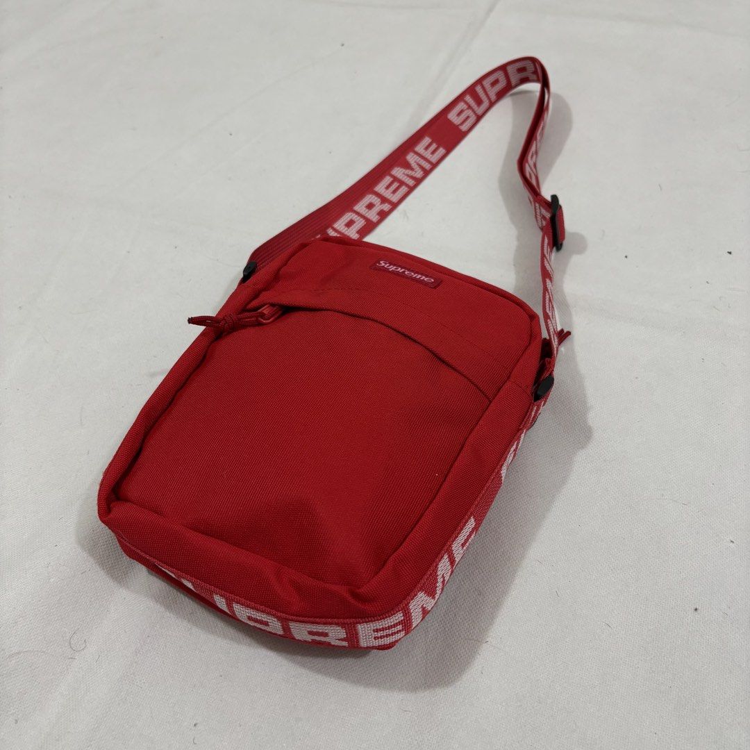 Supreme Red Shoulder Bag Crossbody (Category: Sling Bags) located in Cavite. Submitted by itsayaaa (Listing ID 1464836882, Image 2). Description: - Brand: Supreme - Color: Vibrant red with bold white logo straps - Storage: Front zip pocket and main compartment with inner zip pocket - Details: Features 'Made in China' inner tag, clean interior lining - Fit: Adjustable strap with durable buckle hardware - Condition: Excellent, clean and well-mainta