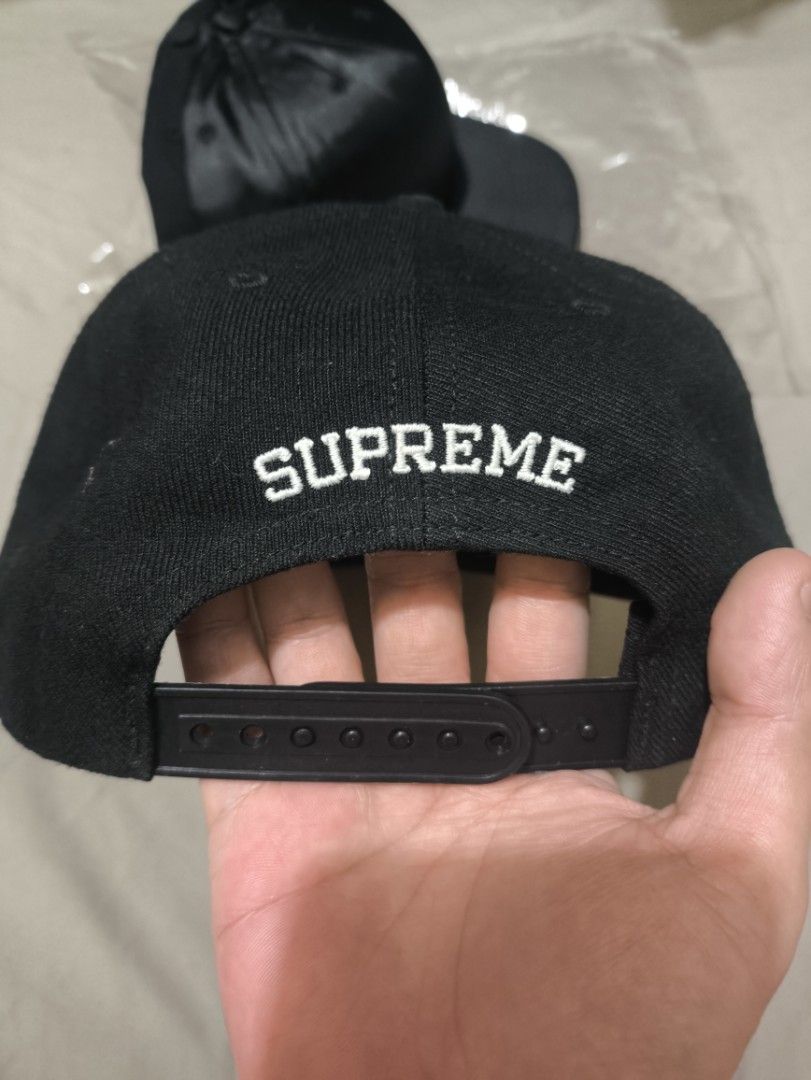 Supreme x Dead Prez Snapback Cap Black (Category: Caps & Hats) located in Manila. Submitted by brewtherat (Listing ID 1464826979, Image 2). Description: - Brand: Supreme x Dead Prez - Color: Black - Features: Embroidered front text/graphic, raised hand-embroidered side patch with red and green bands, and Supreme lettering above the adjustable snap closure - Condition: Interior band has some wear and staining near the front forehead area - 1 missi
