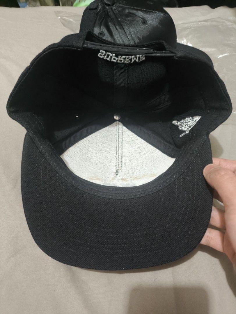 Supreme x Dead Prez Snapback Cap Black (Category: Caps & Hats) located in Manila. Submitted by brewtherat (Listing ID 1464826979, Image 3). Description: - Brand: Supreme x Dead Prez - Color: Black - Features: Embroidered front text/graphic, raised hand-embroidered side patch with red and green bands, and Supreme lettering above the adjustable snap closure - Condition: Interior band has some wear and staining near the front forehead area - 1 missi