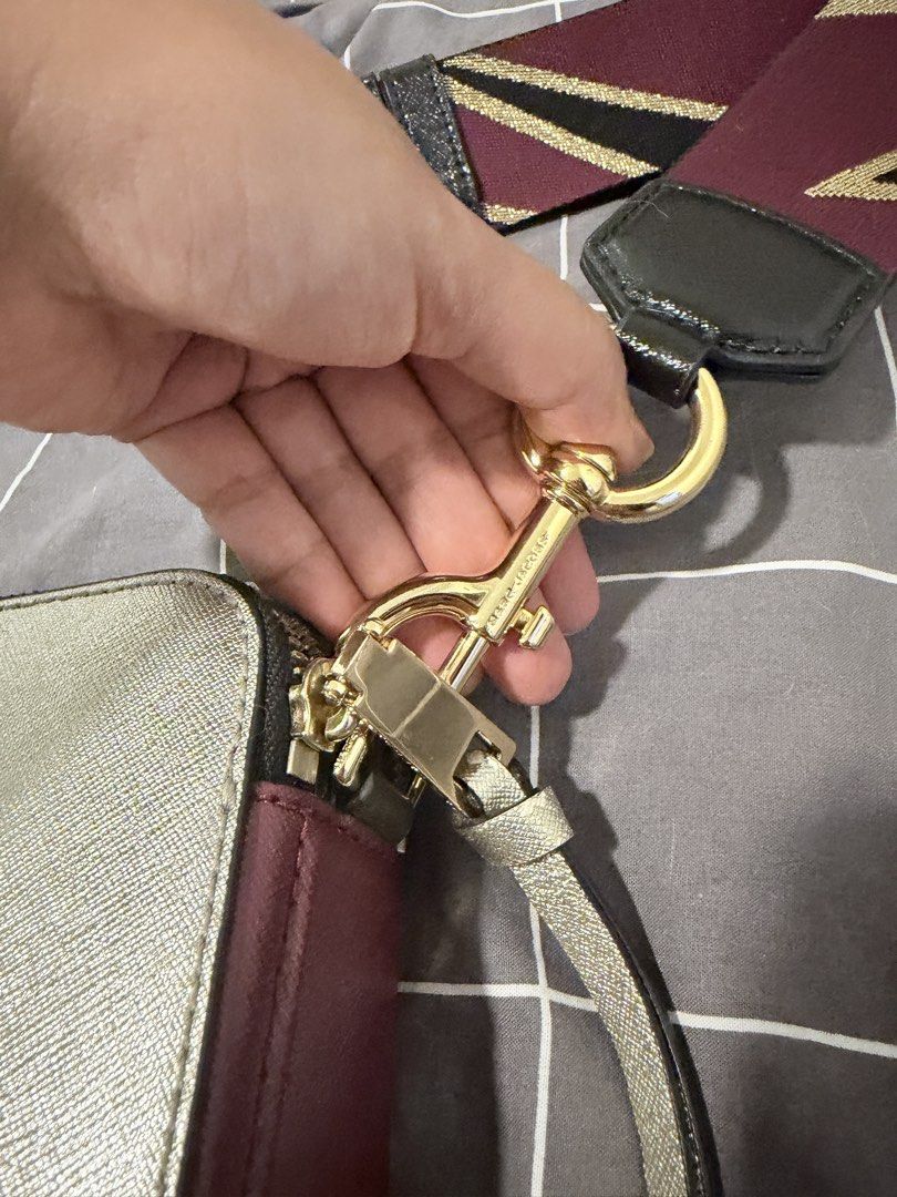 The Marc Jacobs Snapshot Camera Bag Silver Burgundy (Category: Luxury Bags & Wallets) located in Makati City. Submitted by purewind.a22dcd (Listing ID 1464861654, Image 2). Description: - Authentic Marc Jacobs Snapshot camera bag - Color: Silver and burgundy metallic - Material: Saffiano leather with gold-tone hardware and double J logo - Features: Dual zip compartments and wide patterned webbing strap - Inclusions: Dust bag and tags - Condition: