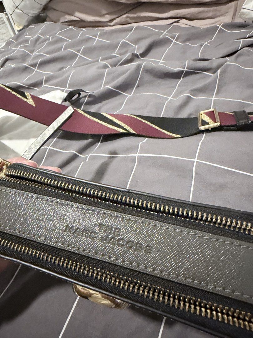 The Marc Jacobs Snapshot Camera Bag Silver Burgundy (Category: Luxury Bags & Wallets) located in Makati City. Submitted by purewind.a22dcd (Listing ID 1464861654, Image 3). Description: - Authentic Marc Jacobs Snapshot camera bag - Color: Silver and burgundy metallic - Material: Saffiano leather with gold-tone hardware and double J logo - Features: Dual zip compartments and wide patterned webbing strap - Inclusions: Dust bag and tags - Condition: