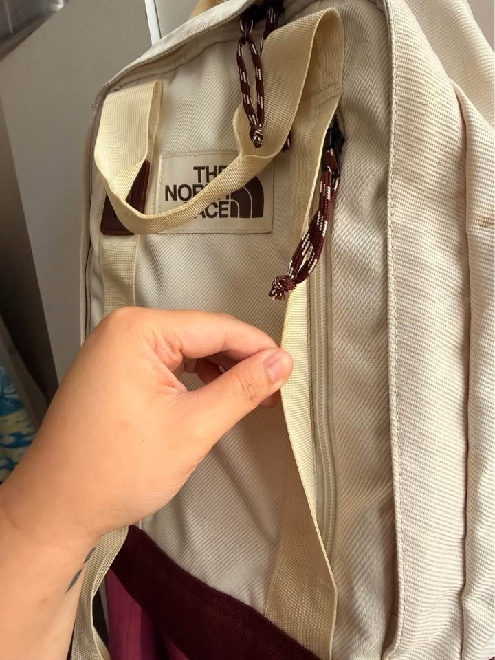 The North Face Off White Brown Tote Pack (Category: Backpacks) located in Caloocan City. Submitted by clemg6 (Listing ID 1464784758, Image 2). Description: - Color & Material: Off-white canvas with a durable brown bottom panel - Closure: Double zip top closure with stylish patterned pull cords - Versatile Carry: Features dual top carrying handles and adjustable shoulder straps - Storage: Classic rectangular shape with a roomy interior compartment