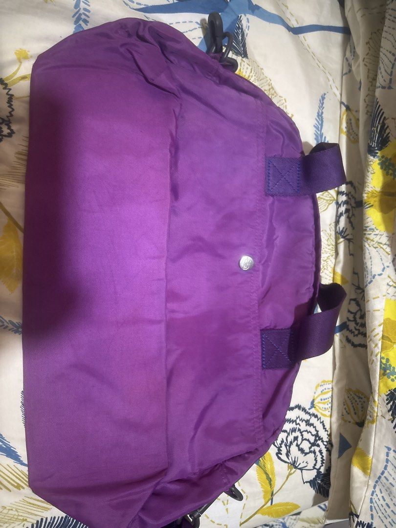 The North Face Purple Duffel Bag (Category: Backpacks) located in Quezon City. Submitted by relyncabubas (Listing ID 1464783693, Image 2). Description: - Brand: The North Face - Color: Bright purple - Material: Durable nylon - Features: Dual top carry handles, embroidered front branding, secure zip main closure .