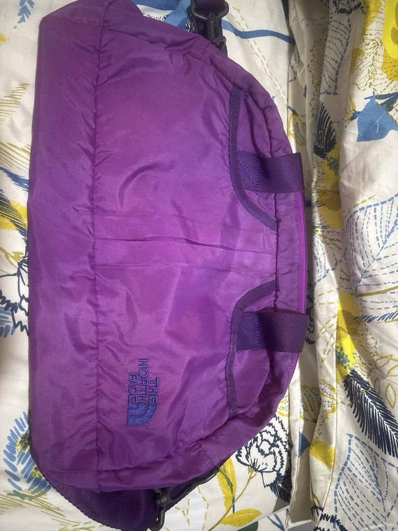 The North Face Purple Duffel Bag (Category: Backpacks) located in Quezon City. Submitted by relyncabubas (Listing ID 1464783693, Image 1). Description: - Brand: The North Face - Color: Bright purple - Material: Durable nylon - Features: Dual top carry handles, embroidered front branding, secure zip main closure .
