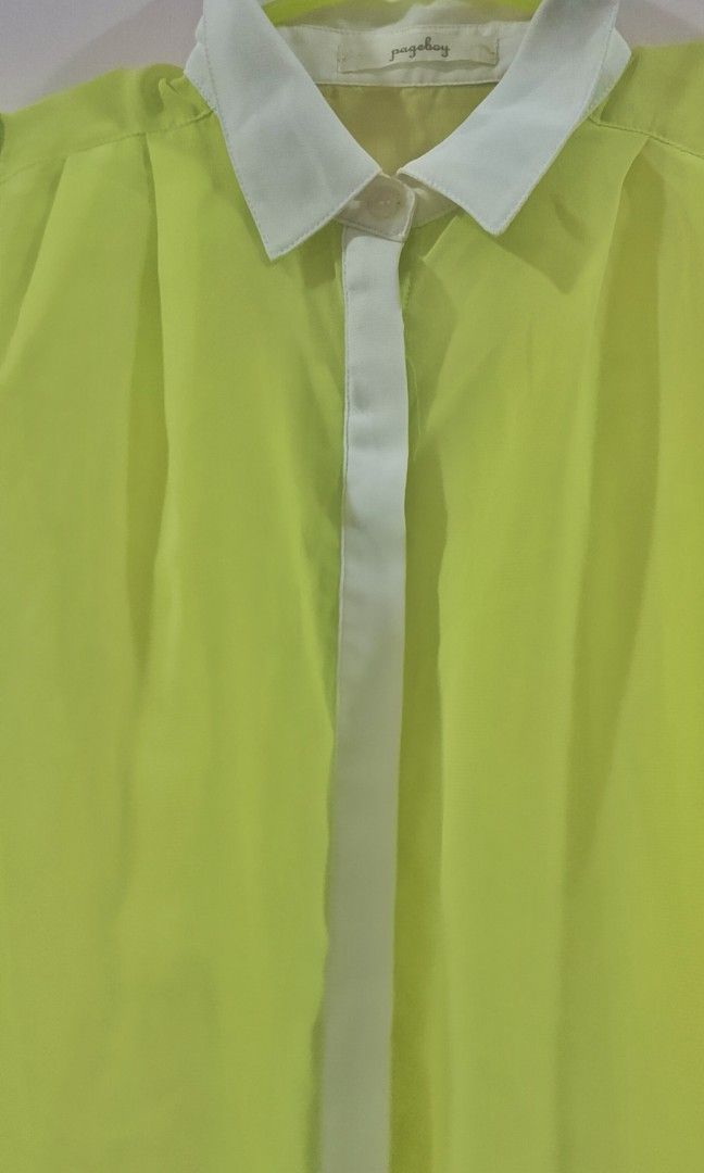 This is a lime green and white sleeveless button-d (Category: Blouses) located in Cabanatuan. Submitted by miss.maia (Listing ID 1464947387, Image 2). Description: This is a lime green and white sleeveless button-down blouse with a contrasting white collar and front placket..
