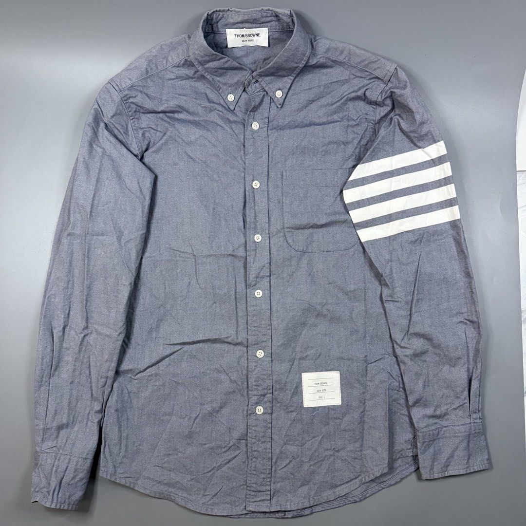 Thom Browne - Chambray 4-Bar Shirt Grey (Category: Luxury Apparel) located in Paranaque City. Submitted by millennial_goodz (Listing ID 1464893187, Image 2). Description: WTS Thom Browne - Chambray 4-Bar Shirt Grey Size 1 Dimensions: 19" / 29" Excellent condition Ready to wear P2,499 only DM.