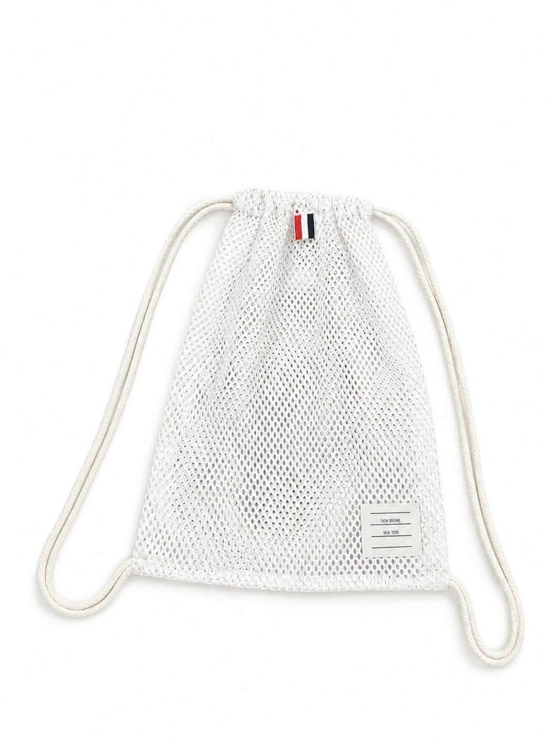 Thom Browne New York White Mesh Drawstring Backpack (Category: Backpacks) located in Tayug. Submitted by cvcthrift (Listing ID 1464901634, Image 1). Description: - Brand: Thom Browne New York -Authentic - Material: Lightweight and breathable white mesh - Straps: Thick cream rope drawstring - Details: Iconic tri-color grosgrain loop tab at the top - Branding: Signature fabric name tag patch on the lower corner - Condition: Excellent, ready to use.