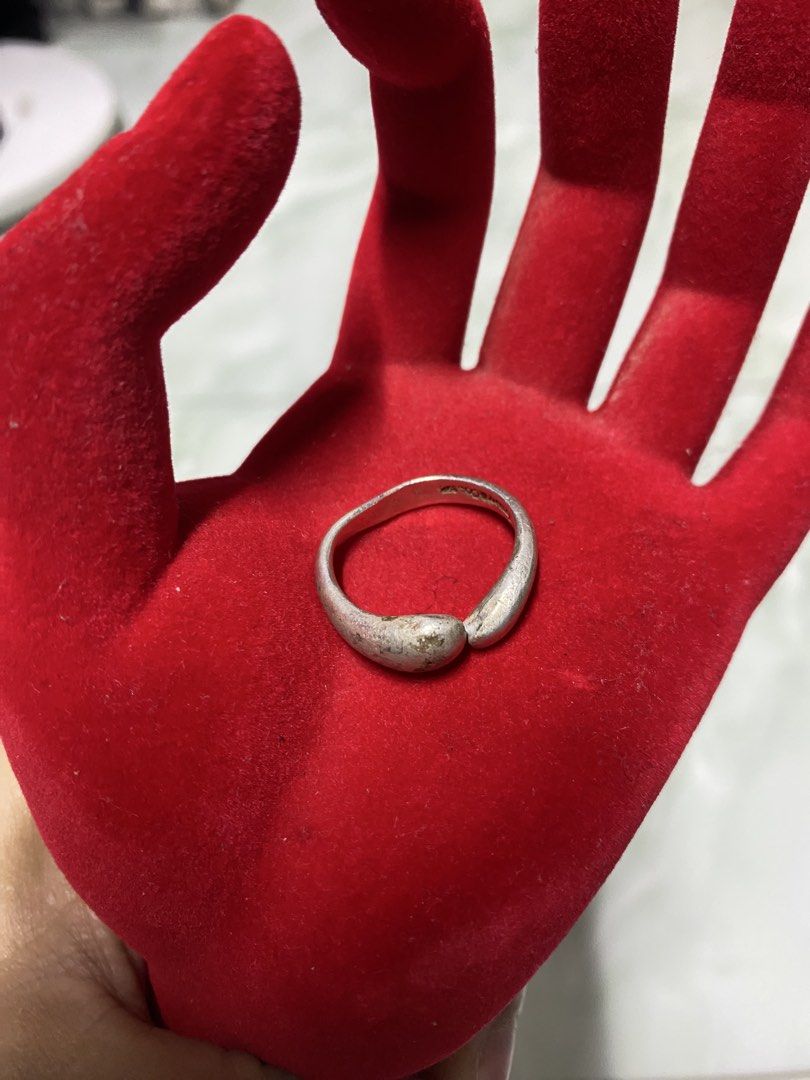 Tiffany & Co. Sterling Silver Bean Ring (Category: Rings) located in Pasacao. Submitted by wengpullar37205 (Listing ID 1464924027, Image 2). Description: - Brand: Tiffany & Co. - Design: Curved bean wrapping around the finger - Material: Sterling Silver (925 hallmark stamped inside band) - Size: US 6 (verified on mandrel) - Weight: 6.76 grams (verified on digital scale) - Condition: Excellent, 100% authentic -palinisan or papolish nio nlng po.