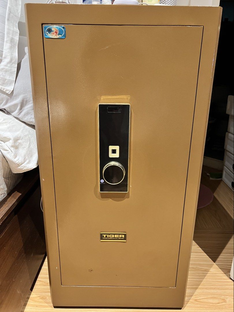 Tiger Professional Safe Bronze Security Cabinet (Category: Safe) located in Taguig. Submitted by fifileen (Listing ID 1464890427, Image 1). Description: Tiger Professional Security Safe in bronze. Heavy-duty steel with digital keypad and dial lock. Ideal for cash, docs, and valuables. Floor-standing model. Self-collection only. 100 cm tall x 50cm length x45 cm width .