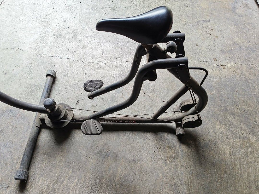 TimeWorks FX stationary exercise bike and stepper (Category: Cardio & Fitness Machines) located in Manila. Submitted by beyondfundraising (Listing ID 1464876913, Image 3). Description: - Brand/Model: TimeWorks FX indoor stationary fitness machine - Workout Type: Full-body workout combining pedaling and upper body handlebar motion - Build: Heavy-duty black metal frame with rubber base feet and integrated saddle seat - Features: Foot pedals and fro